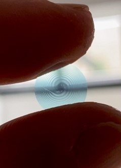 The new lens could be used on contact lenses (shown), in intraocular implants for cataracts, and to create new types of miniaturized imaging systems. Courtesy of Laurent Galinier.