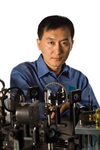 Dr. Chunlei Guo of the University of Rochester stands in front of his femtosecond laser. 