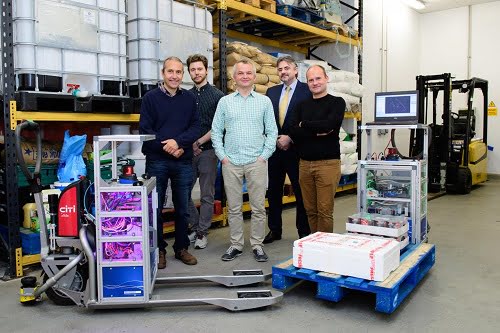 Pictured L-R with the forklift prototypes is Professor Tom Duckett, Principal Investigator for the University of Lincoln's ILIAD team, Dr Martin Magnusson from Örebro University, and the rest of the team at Lincoln, Dr Grzegorz Cielniak, Mark Swainson, and Dr Marc Hanheide. 