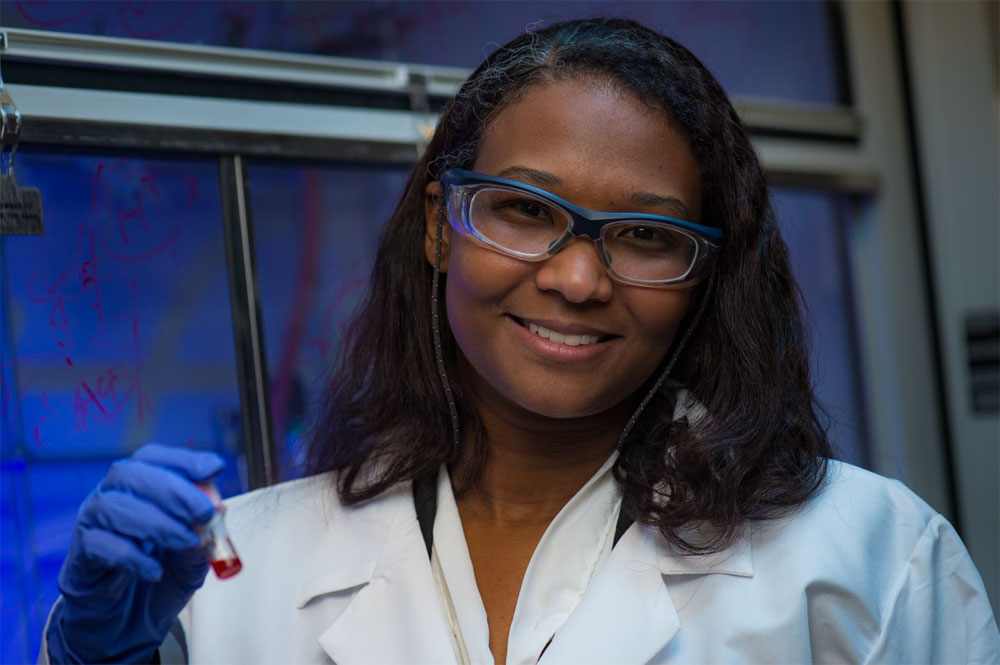 Rice University’s Eilaf Egap, an assistant professor of materials science and nanoengineering and chemical and biomolecular engineering, holds a vial of quantum dots her lab is using to catalyze the creation of functional polymers. Courtesy of Jeff Fitlow/Rice University.