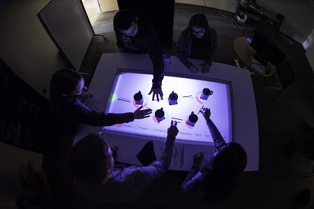 Students simulate reactions in a chemical plant using an augmented reality tabletop developed in the lab of Andrew White, assistant professor of chemical engineering, at the University of Rochester. Courtesy of University of Rochester photo/J. Adam Fenster.