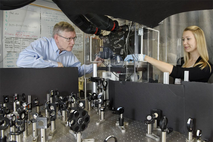 Professor W. E. Moerner, left, and postdoctoral scholar Anna-Karin Gustavsson position a sample on the new TILT3D microscope. Stanford University.
