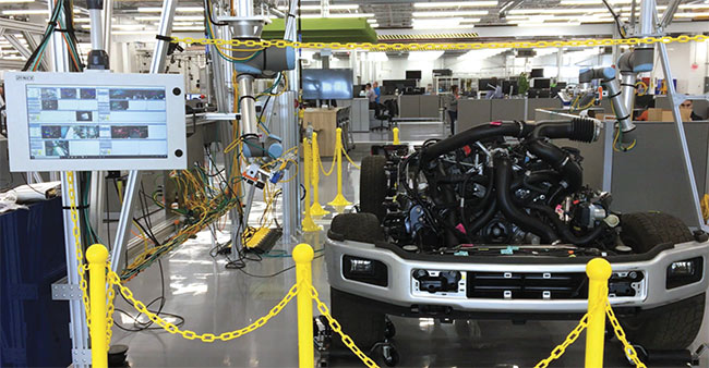  A robot equipped with two cameras performs a flexible inspection on an engine and chassis. Courtesy of Ford Motor Co..