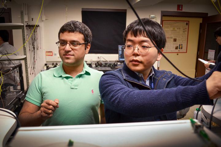 Mechanical sciences engineering professor Gaurav Bahl, (l), and graduate student Seunghwi Kim confirmed that backscattered light waves can be suppressed to reduce data loss in optical communications systems. Courtesy of Julia Stackler, University of Illinois at Urbana-Champaign.
