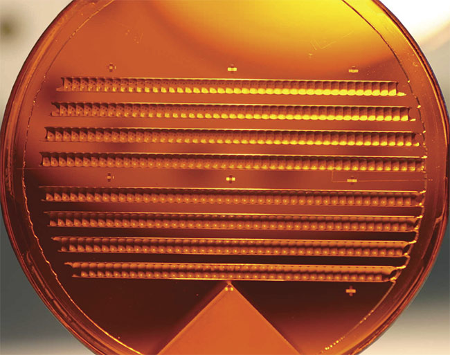 A custom 50-mm-diameter gallium phosphide microlens array used for collimation of individual emitters in an infrared laser array. The ability to place multiple custom lenses together in a small space at high tolerances facilitates extremely compact form factors. Courtesy of JENOPTIK.