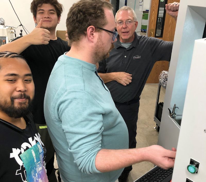 Students in the Front Range Community College (FRCC) Optics & Laser Technology program train with Dave Mohring from OptiPro on a computer numerical control (CNC) optics generator.