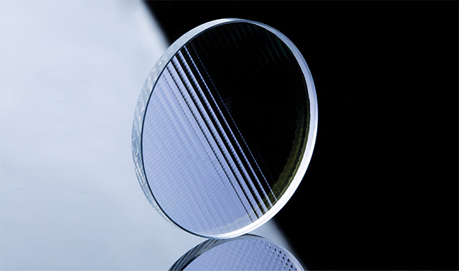 A variety of microlenses produced at wafer scale (top). High-power lasers incorporate combinations of such microlenses with different sizes and focal lengths to achieve the desired beam output. A homogenizer for shaping high-power beams (bottom) Courtesy of Focuslight.