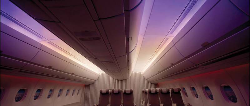 An airplane’s cabin with the sunrise setting (bottom). Courtesy of Quantas.