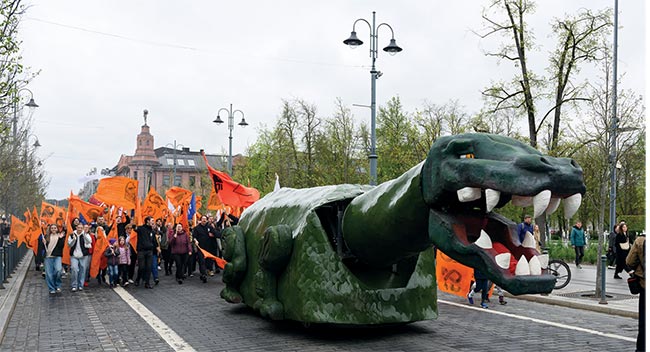 Vilnius hosts the Day of Physics (FiDi) and its annual parade (top). The famed dinosaur leads the pack.  Gediminas Raciukaitis, head of the laser department of the Center for Physical Sciences and Technology (FTMC) and president of the Lithuania Laser Association in Vilnius, Lithuania, leads a session at the EPIC Technology Meeting on Laser Microprocessing (middle).  Four company visits and 20 presentations highlighted the proceedings of the 2024 EPIC Technology Meeting on Laser Microprocessing (bottom). The meeting was held in Vilnius, Lithuania, Sept. 25 to 26. Courtesy of EPIC, Nail Garejev, Andreas Thoss.