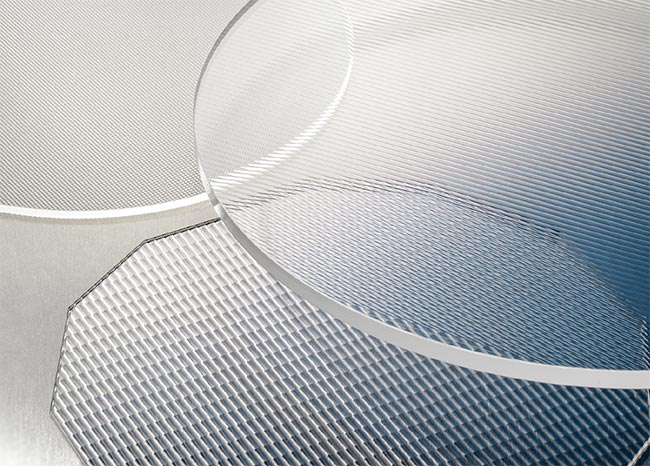 A fiber coupler array (the final product) compared to a wafer (top). Both are made from a glass with a high refractive index.  Offering a wide range of element sizes is crucial to meeting the needs of various micro-optics applications (bottom). Courtesy of Focuslight Technologies.