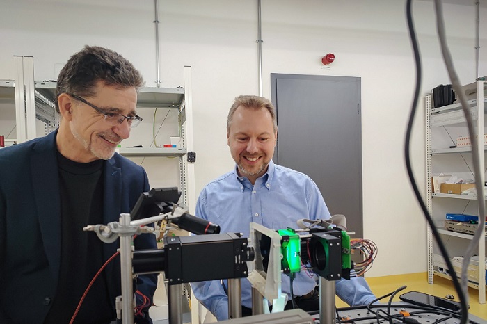 Professor Andreas Waag of Technische Universität Braunschweig (TU Braunschweig) and professor Christian Werner of Ostfalia University of Applied Sciences at the demonstrator for an LED-based neuromorphic computer. Courtesy of TU Braunschweig/Laurenz Kötter.