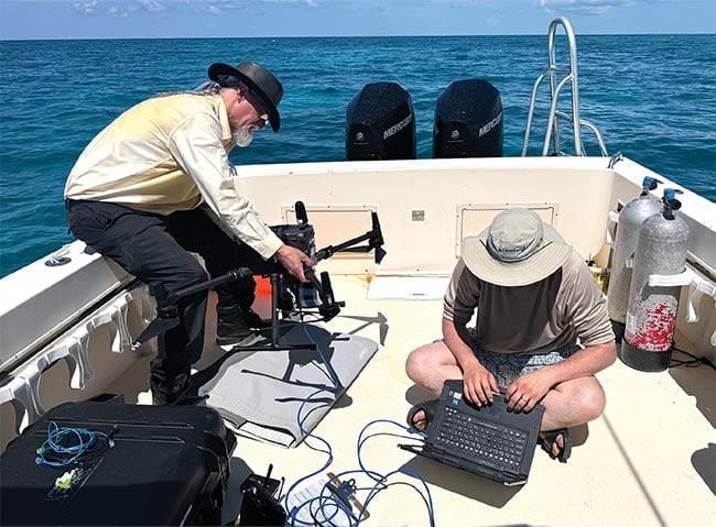 Optical sensors have been shrunk to easily mount onto uncrewed aerial vehicles (UAVs) (top). Hyperspectral imaging sensors can now weigh <5 kg, offering users more options for deployment.  Scanning coral tanks onshore with uncrewed aerial vehicle (UAV)-mounted sensors allows scientists to gather valuable data in their mission to conserve and restore oceanic species along the Florida coast (bottom). Courtesy of Headwall.