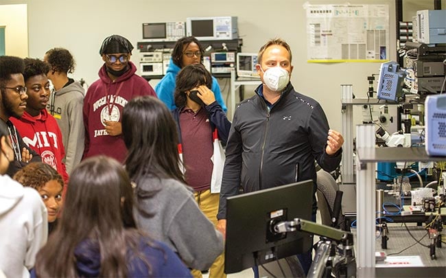 Students from John J. Duggan Academy in Springfield, Mass., examine integrated photonics measurement equipment during a visit to Western New England University. Courtesy of Spark Photonics Foundation.