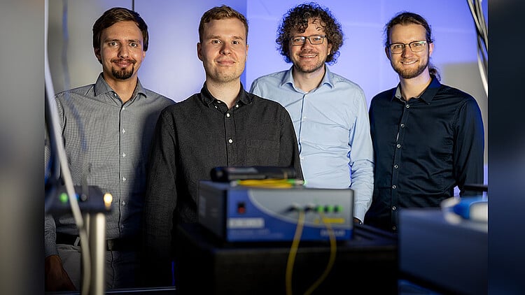 (From left) Researchers Jan Heine, Philip Rübeling, Michael Kues, and Robert Johanning have developed a concept to enable the cohabitation of quantum and conventional internet signals in the same optical fiber without the need to multiplexing. Courtesy of Leibniz University Hannover.