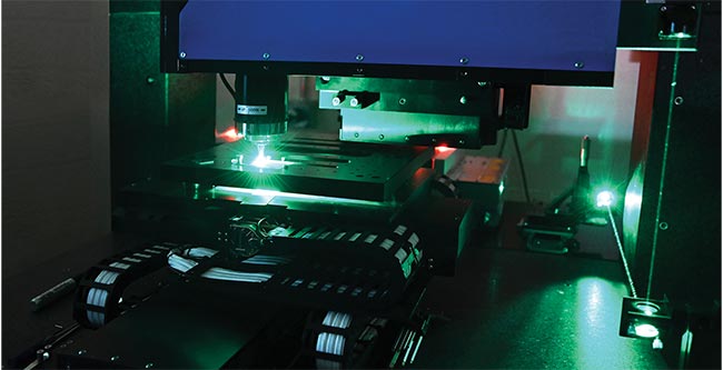 Aerotech’s 515-nm, five-axis laser micromachining center with drilling operation using a femtosecond laser. Courtesy of Aerotech.