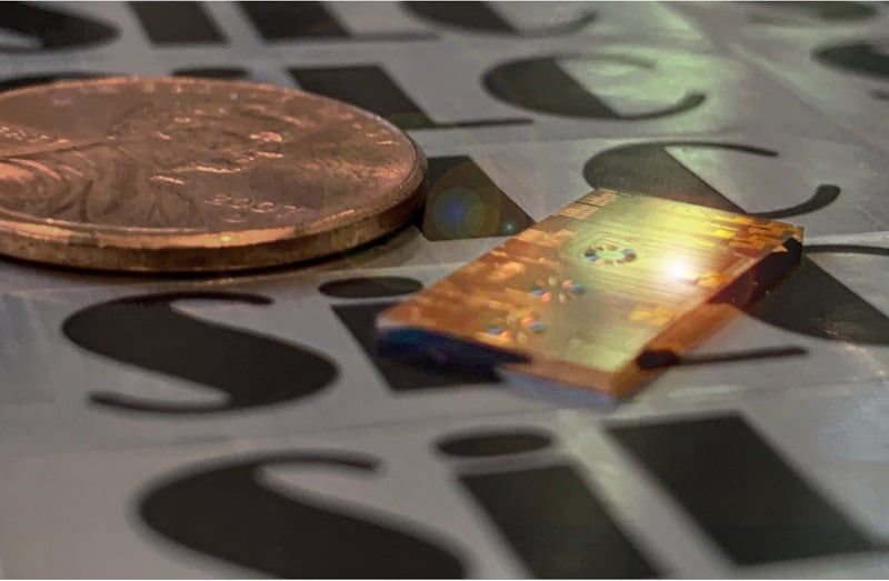 SiLC’s integrated single chip FMCW lidar technology compared to a penny. Courtesy of SiLC Technologies.