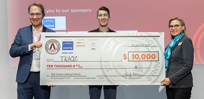 Jenoptik’s Ralf Kuschnereit (left) and 2024 SPIE President Jennifer Barton (right) pose with Benjamin Dringoli (middle) of TRAQC, the winner of the SPIE Startup Challenge 2024. Courtesy of SPIE.