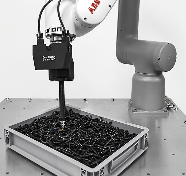 Bin picking performed using two standard industrial cameras (housed in a black enclosure) spaced a known distance apart to generate 3D information. Courtesy of Cambrian Robotics.