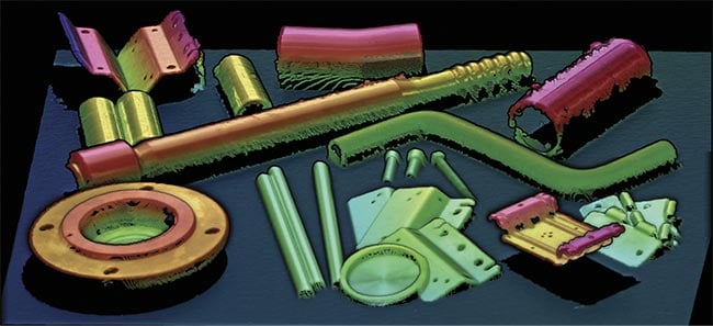 An assortment of industrial parts that could be bin picked, seen in a 3D point cloud (top) and in color (bottom), generated by a 3D camera. The 3D data that shows the position in space of a surface is essential to bin picking. Courtesy of Zivid.