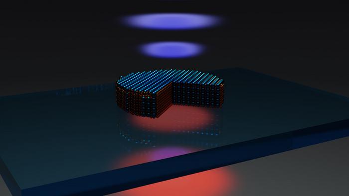 Schematic of the optical experiment: Excitation of a near-infrared laser (red bottom one) excites the nanodisk fabricated from the 3R-molybdenum disulfide flake, standing on a glass substrate. The quarter-cut-section of the disk schematically shows that the incident laser excites optical resonances, leading to red areas in the image that represent the higher density of the electromagnetic field. This localization, along with the crystalline lattice broken inverse symmetry, allow for effective conversion of the red pump laser into blue light (doubled frequency). Courtesy of Chalmers University of Technology/Georgii Zograf.