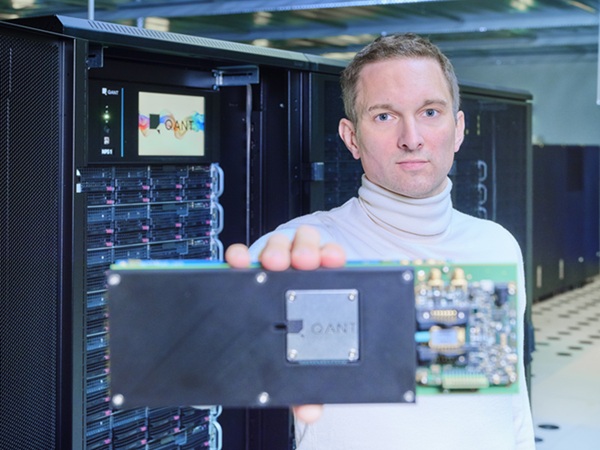 Q.ANT founder and CEO Michael Förtsch holds the company’s commercial photonic processor, designed for real-world AI and high-performance computing workloads. Courtesy of Q.ANT.
