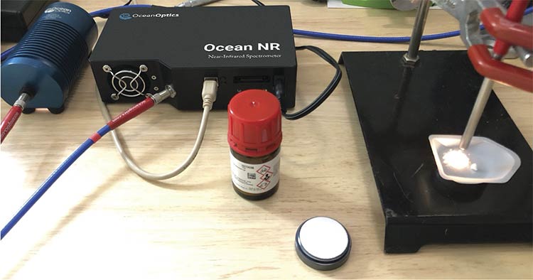 A spectroscopy setup featuring the Ocean NR Near-Infrared Spectrometer by Ocean Optics. This system is commonly used in pharmaceutical quality control, material characterization, and chemical composition analysis, where NIR spectra provide insights into molecular structure, moisture content, and other physical or chemical properties. Courtesy of Ocean Optics.