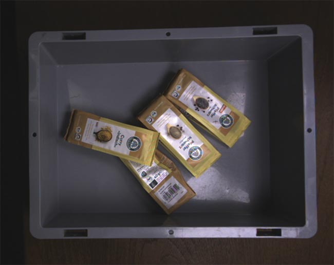 Bags in a box, captured by one camera in a dual stereo vision system (top). An AI evaluation result from combining left and right images in a stereo vision system. Four bags were detected, with grasp points labeled .0 to .3 (bottom). Courtesy of Basler.