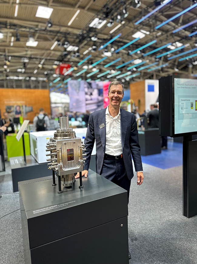 Tom Metzger, CEO of TRUMPF Scientific Lasers, presents a 10-J, 100-Hz amplifier head based on multiple ytterbium-doped YAG (Yb:YAG) slabs developed by colleagues at TRUMPF Laser SE. The TRUMPF Scientific Lasers team plans to adapt the system for ytterbium glass (Yb:glass) operation. Courtesy of TRUMPF.